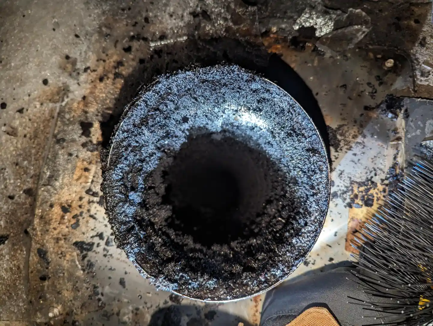 Close-up of creosote buildup inside a chimney flue